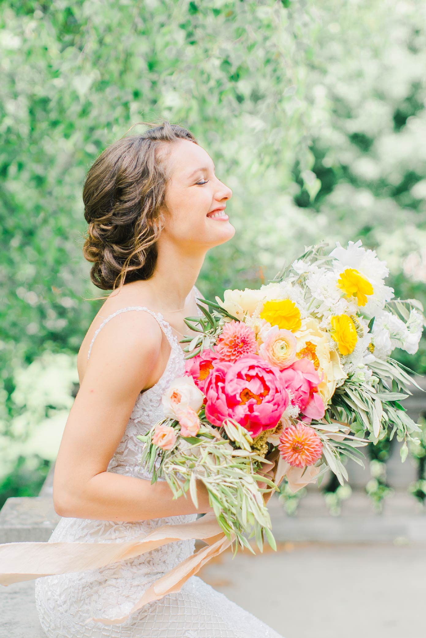 Bride posing with a colorful bouquet